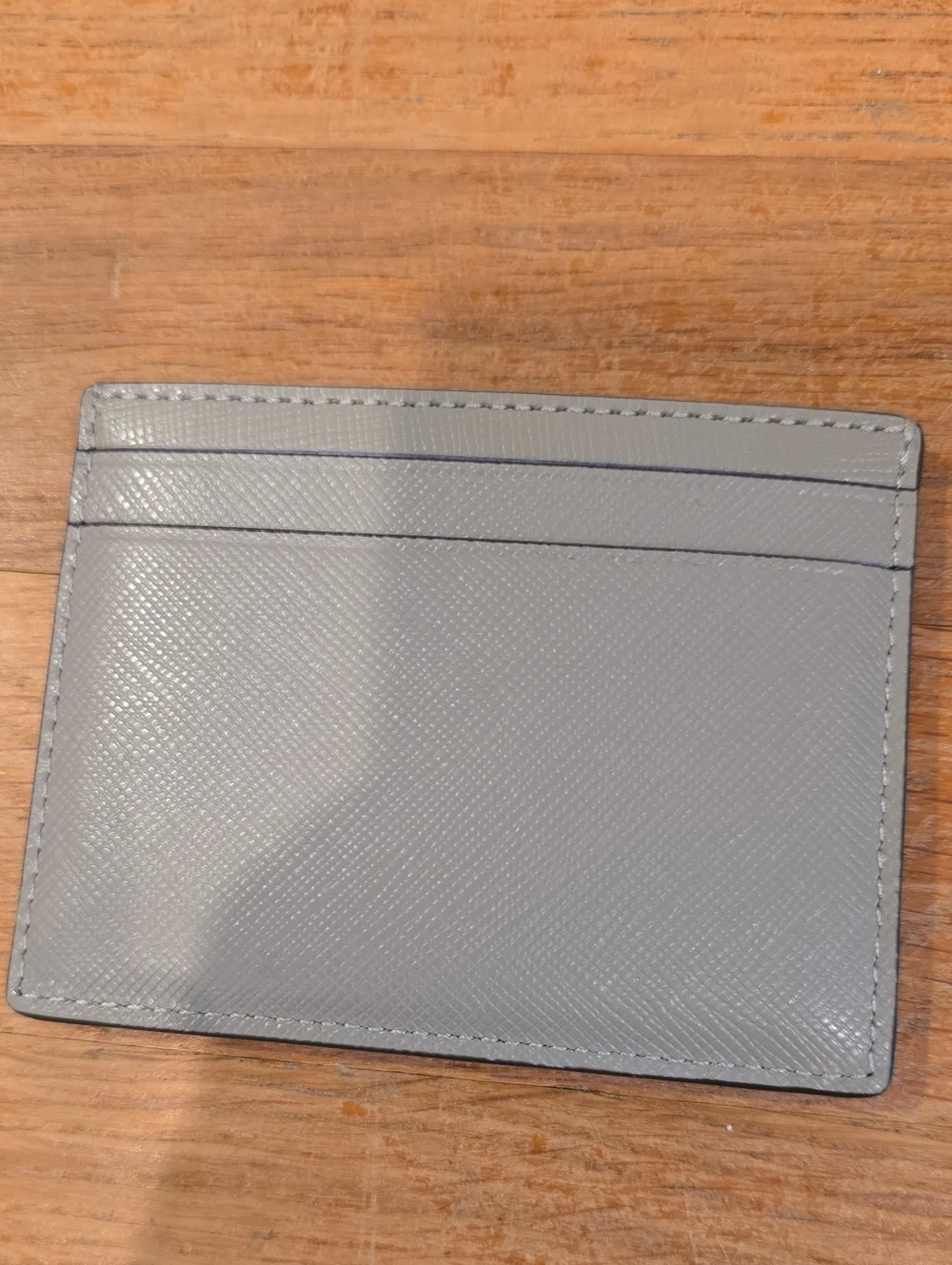 Kate Spade gray saffiano card holder with gold logo